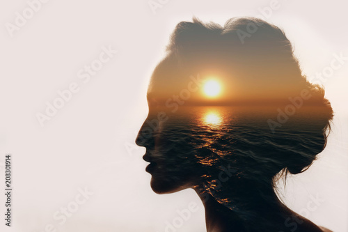 Psychology concept. Sunrise and woman silhouette. photo