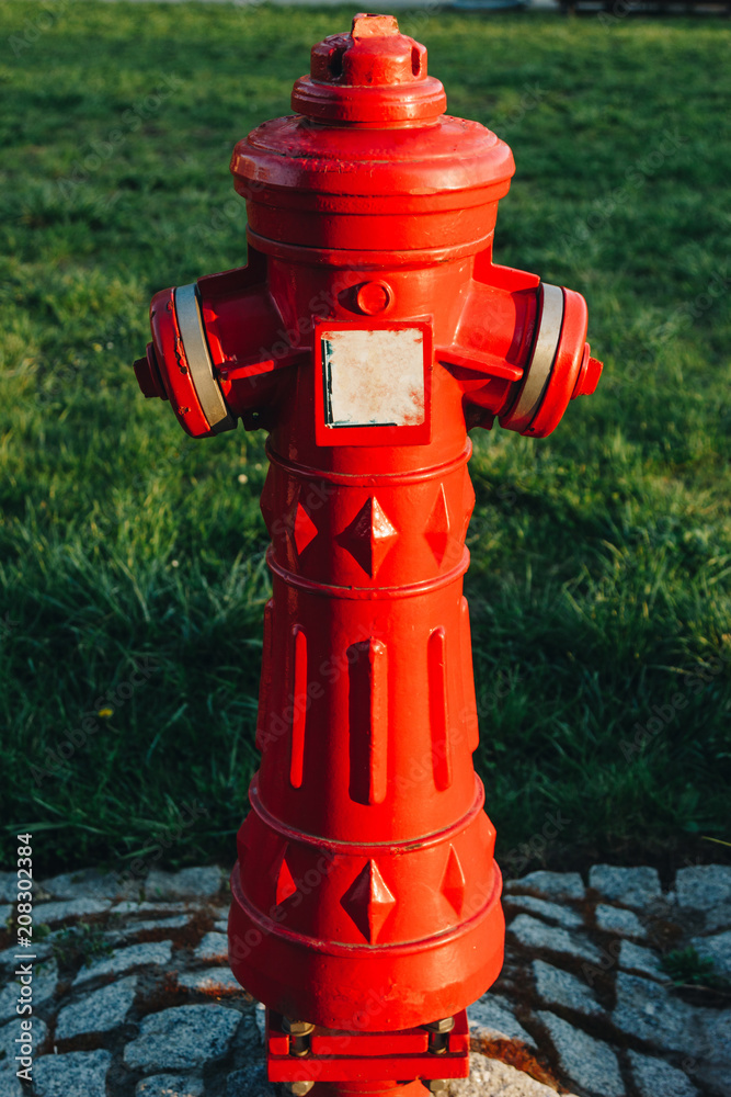 close-up shot of red antique fire hydrant on street of wroclaw close-up shot of red antique fire hydrant on street of wroclaw
