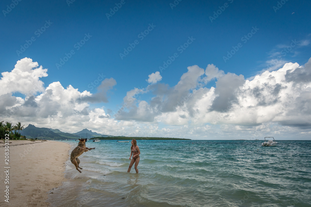 Bikini girl and shepherd on the Mauritius beach