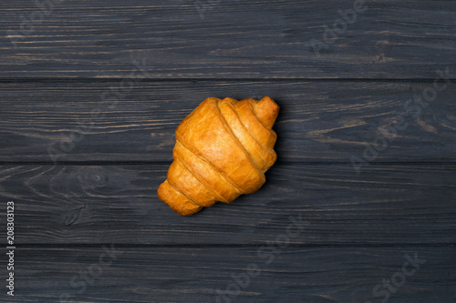 Fresh croissant on a black wooden background. Top view Copy space photo