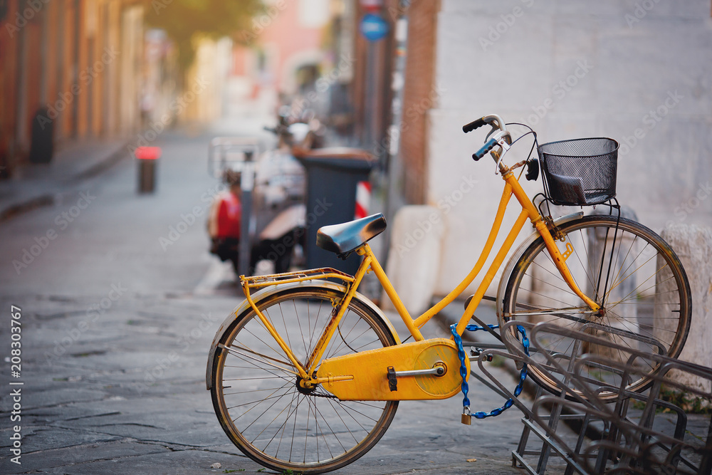 Beautiful vintage yellow bicycle on the old Italy street