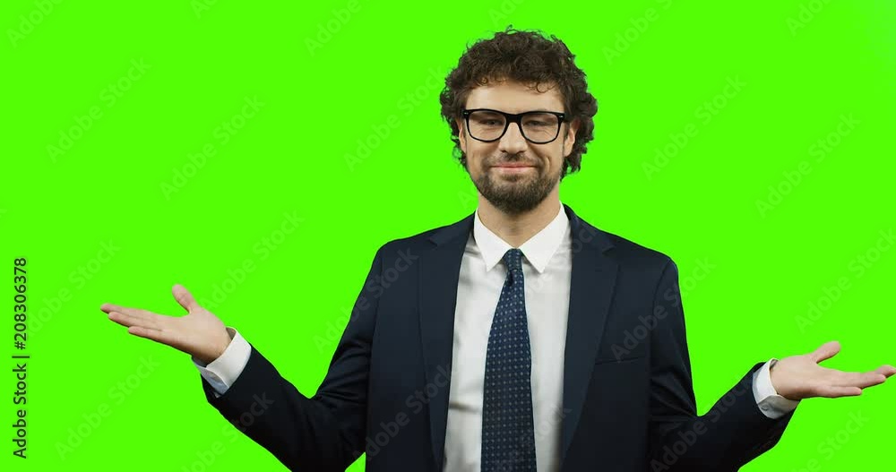 Smiled Caucasian man in suit and tie doing gesture with hands like I don't know or whatever on the green screen background. Chroma key. Smiled Caucasian man in suit and tie doing gesture with hands like I don't know or whatever on the green screen background. Chroma key.