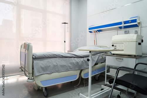 Empty Bed On Hospital Ward. Hospital room with bed and comfortable medical equipped in a modern hospital