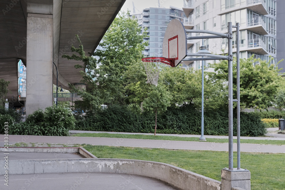 Basketball court in urban area. Dusk, dramatic view. Vancouver BC, Canada Basketball court in urban area. Dusk, dramatic view. Vancouver BC, Canada