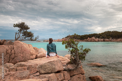 Woman on the rocks of Capriccioli beach,Italy photo