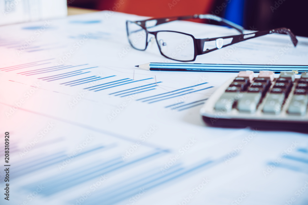Many charts and graphs with pencil. Reflection light and flare. Concept image of data gathering and statistical working. Many charts and graphs with pencil. Reflection light and flare. Concept image of data gathering and statistical working.