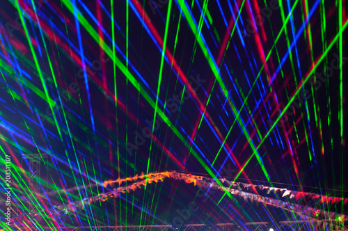 Laser disco rays on a dark background, close up