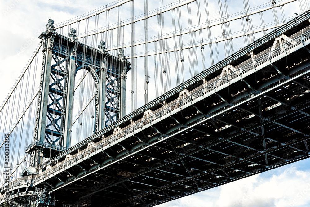 Fototapeta premium Closeup isolated against blue sky view of under Manhattan Bridge in Brooklyn outside exterior outdoors in NYC New York City