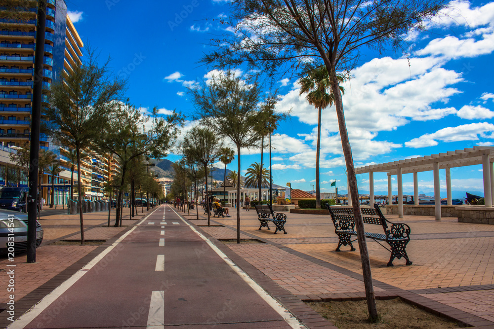 Promenade. A sunny day on the beach of Fuengirola. Malaga province, Andalusia, Spain. Picture taken – 5 june 2018.