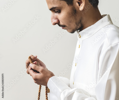 Muslim man with prayer beads photo