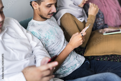 Muslim friends using social media on phones photo