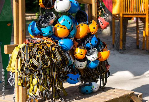 colorful helmets for kids and adults in the rope park in summer. active sport lifestyle