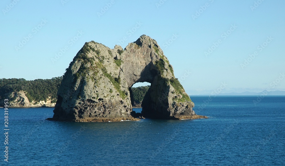 A large arched rock rising the ocean. A large arched rock rising the ocean.