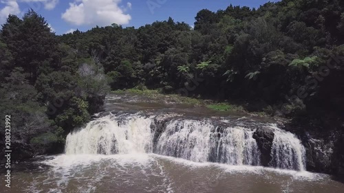 Slow aerial reveal of Wharepuke falls and native new zealand bushlands. Kerikeri. photo