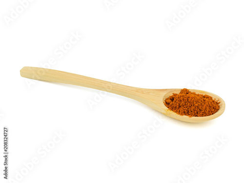 Spoon with red pepper isolated on white background.