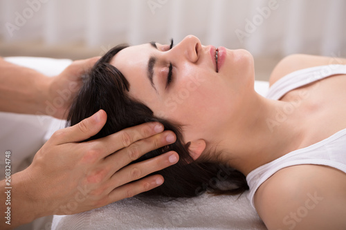 Woman Receiving Acupuncture Treatment