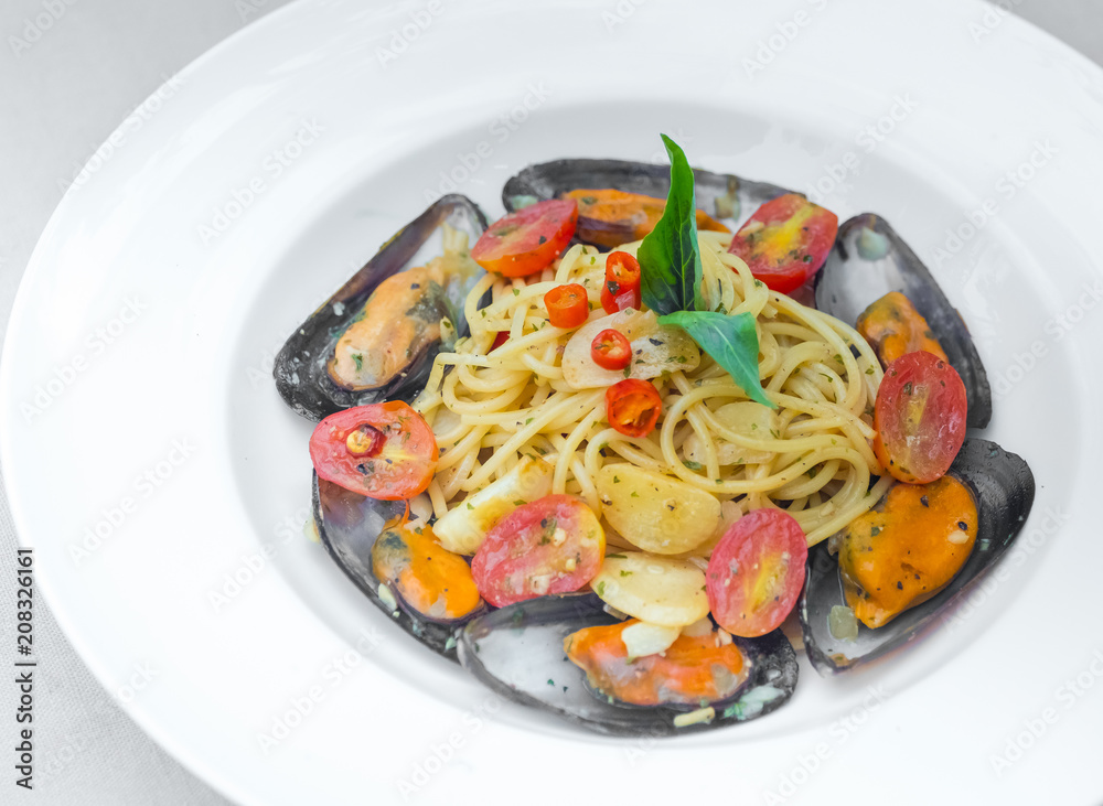 Pasta spaghetti with mussel and tomatoes isolated on white plate Pasta spaghetti with mussel and tomatoes isolated on white plate