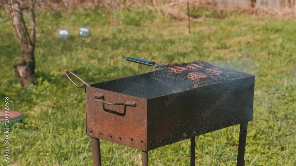 Beef cutlets on the grill brazier. Close-up.