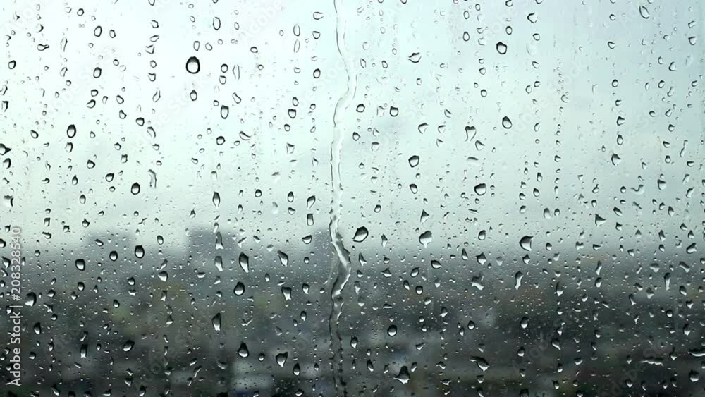 Depression and dreary sad weather shown as water droplets on a window. Depression and dreary sad weather shown as water droplets on a window.