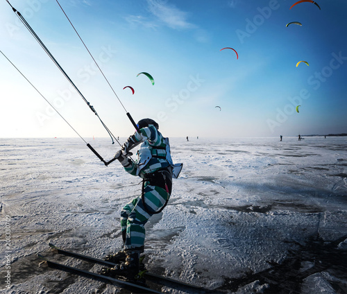 Kitesurfing in the winter. Skating on the ice in the wind.