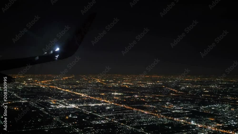 Bangkok, Thailand- Jun 4, 2018. Thai Airasia airline flight FD 3010 fly from Phuket (HKT) to Donmuang Bangkok (DMK) is landing. View from window seat Illuminated city in dark night. 