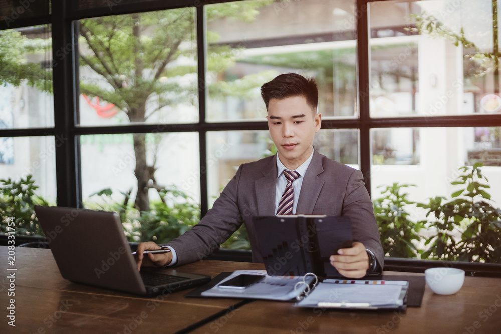 Business man working at office with laptop and documents on his desk, consultant lawyer concept Business man working at office with laptop and documents on his desk, consultant lawyer concept