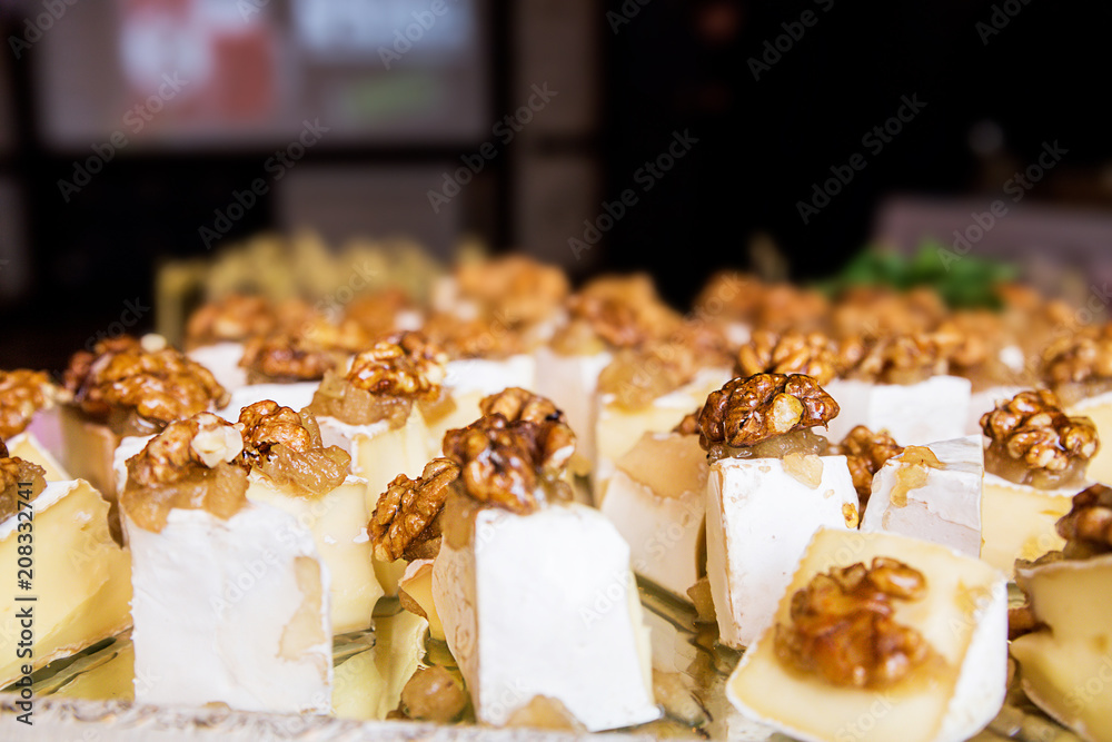 pieces of cheese with walnuts and honey