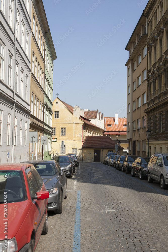 Perspective of a street in a European city Parked cars Background blurred