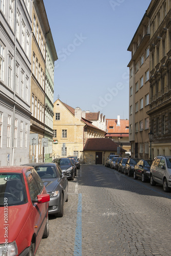 Perspective of a street in a European city Parked cars Background blurred © biggur