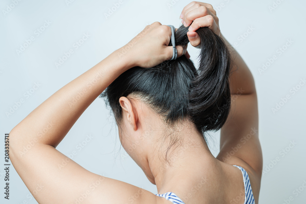 Fototapeta premium rear view of women tightening the hair, lifestyle concept