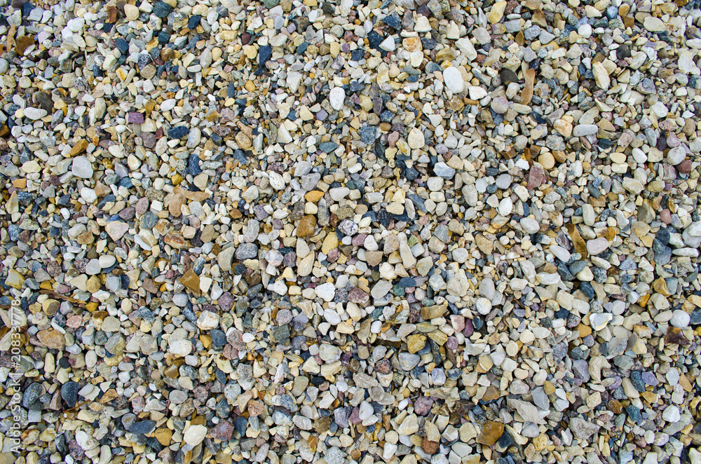 Small stones and pebbles on the ground. Texture background Small stones and pebbles on the ground. Texture background