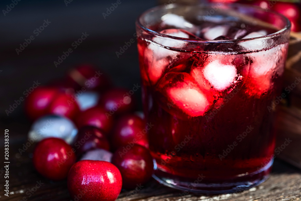 Fresh cherries ice cubes and cherry juice on wood Fresh cherries ice cubes and cherry juice on wood