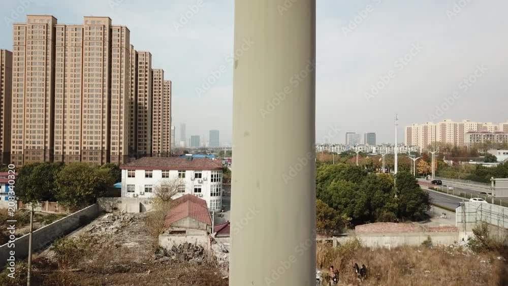 very high GSM antenna stands on the background of the city aerial shooting very high GSM antenna stands on the background of the city aerial shooting