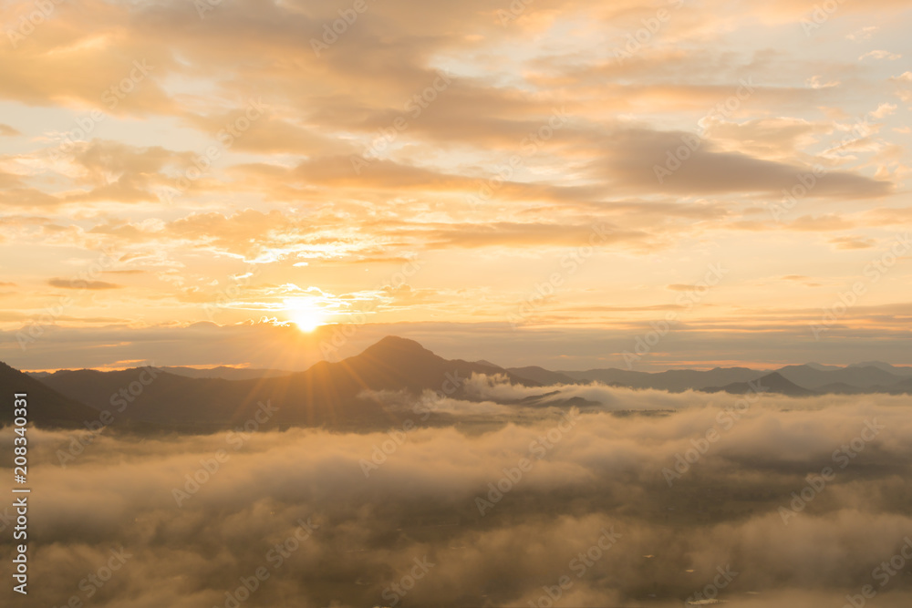 beautiful sunrise over mountain with fog 