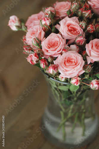 Pink Beautiful Roses Bouquet over Wooden Table. Top view Copy Space. Vintage Greeting Card