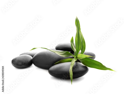 Pile of spa stones and leaves on white background