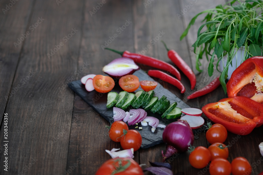 vegetables for salad on an old wooden table.