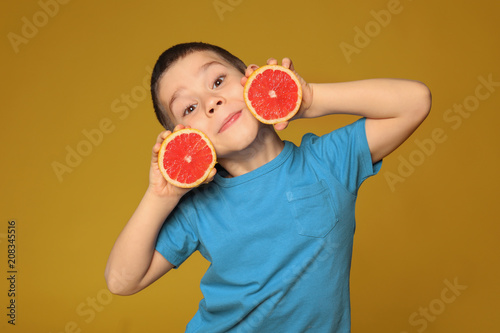 Funny little boy with citru...