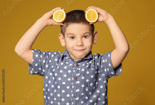 Funny little boy with citru...