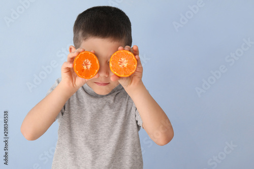 Funny little boy with citru...