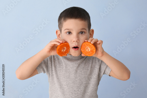 Funny little boy with citru...