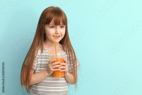 Funny little girl drinking ...