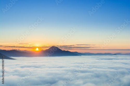 beautiful sunrise over mountain with fog 