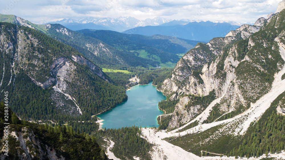 Aerial view of the crystal clear lake Lago Di Braies with house