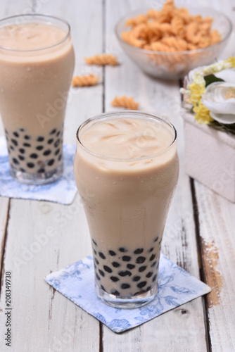 Milk tea with pearls on wooden table.