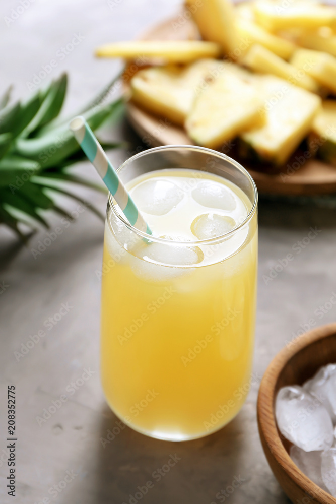 Glass of tasty fresh pineapple juice on table Glass of tasty fresh pineapple juice on table