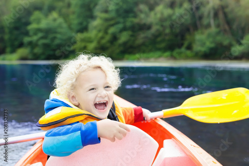 Child on kayak. Kids on canoe. Summer camping.