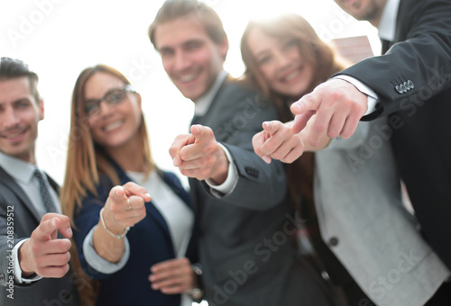 A group of people in business clothes and pointing at you