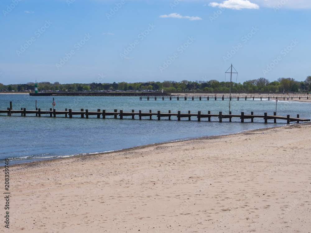 beach on the baltic sea with a view of two wooden bridges beach on the baltic sea with a view of two wooden bridges