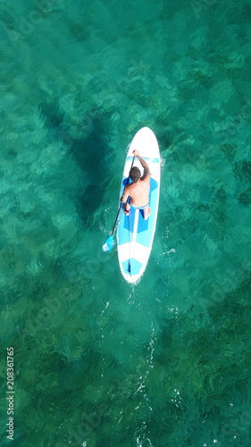 Aerial drone bird's eye view of paddle surfer in turquoise tropical clear waters © aerial-drone